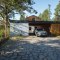 Southern view of the driveway to the house. The covered parking space is equipped with a wallbox for charging electric vehicles Southern view of the driveway to the house. The covered parking space is equipped with a wallbox for charging electric vehicles